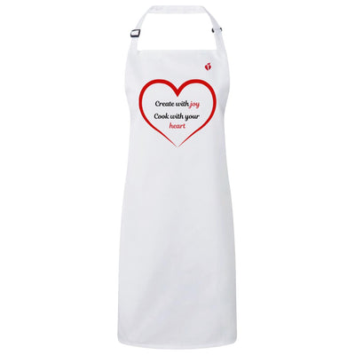 white apron with adjustable buckle neck, aha heart and torch logo on left chest, a red heart outline with words inside that say: "Create with joy. Cook with your heart."