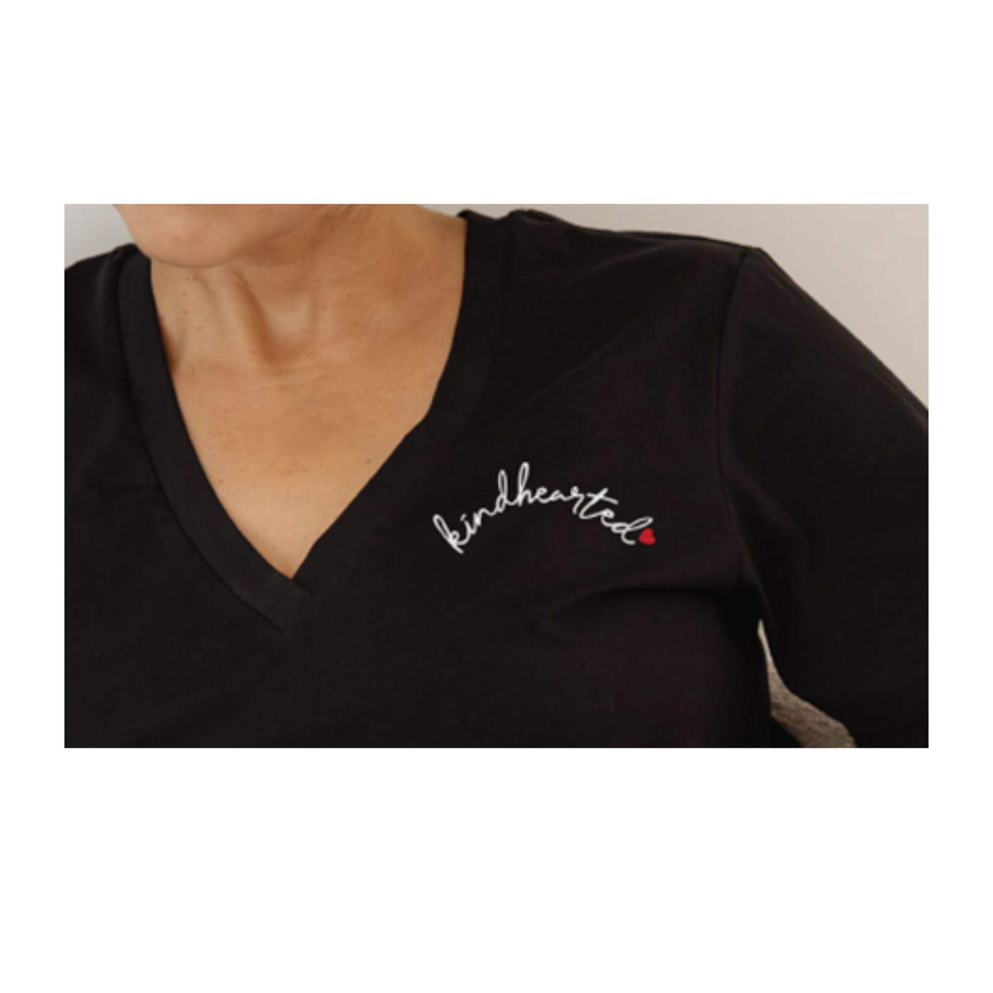"kindhearted" on the chest of a black vneck shirt - ladies
